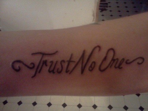Black shaded trust no one tattoo design