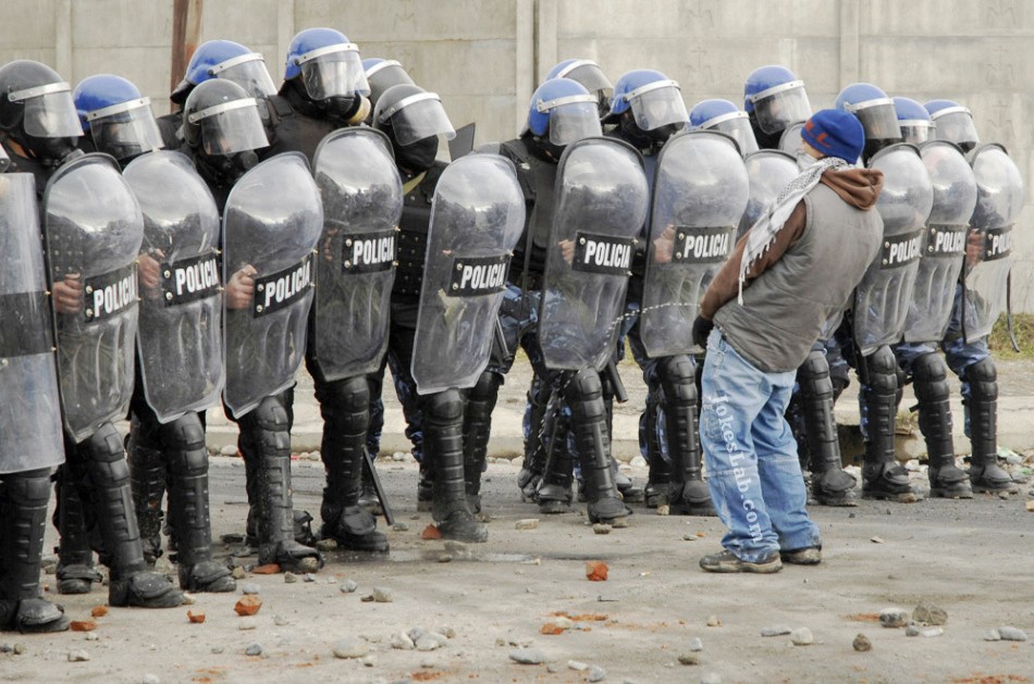976041923-funny-protester-peeing-on-riot-police.jpg