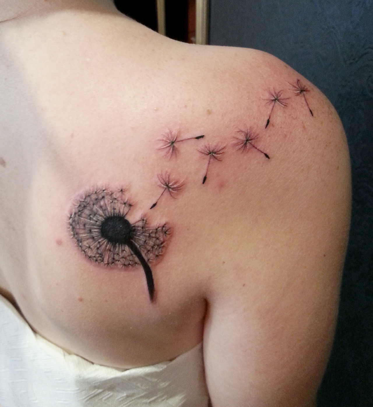 Dandelion temporary tattoo located on the tricep.