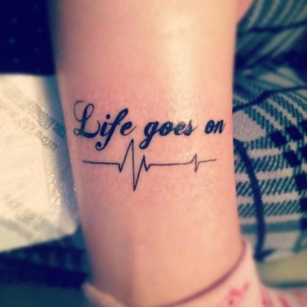 Tattoo that says life goes on written on the inner