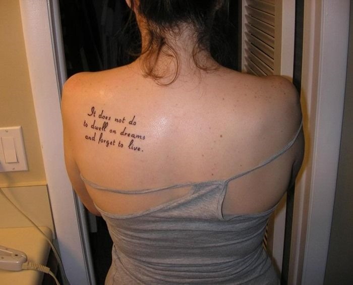 Arabic quote tattoo on the shoulder blade