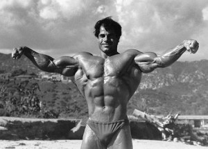 Franco Columbu posing with his huge arms and lats