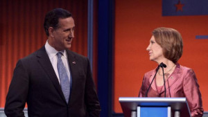 Republican presidential hopeful Rick Santorum (L) speaks with opponent ...