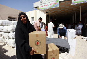 Iraqis displaced by ISIS collect Red Cross aid. Haidar Hamdani/AFP ...