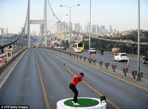 ... Woods hits a ball across the Bosphorus Bridge in Istanbul, Turkey