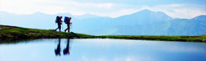 Hikers walking by a lake.