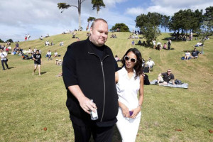 Kim Dotcom and his wife Mona walk during his Internet Party pool party ...