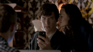 Adler kissing Sherlock to encourage him to crack the code.
