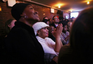 Akilah Rosado (C) and others watch U.S. President Barack Obama's State ...