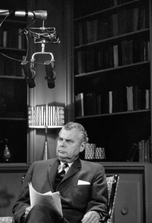 Photograph of John G. Diefenbaker seated in a radio broadcast studio ...