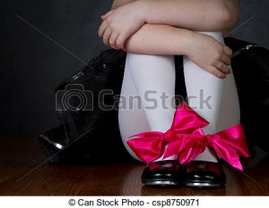 Tap shoes on a little girls feet, dark background room for copy space
