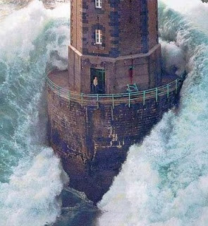Notice the lighthouse keeper standing casually in the doorway!