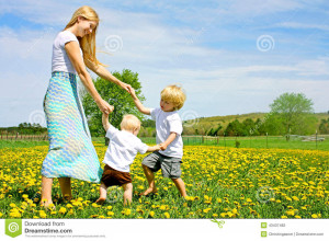 ... : Mother and Children Playing and Dancing Outside in Flower Meadow