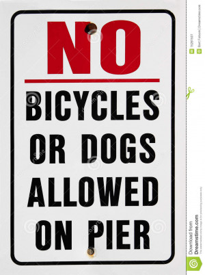 warning sign saying no bicycles or dogs allowed on pier.
