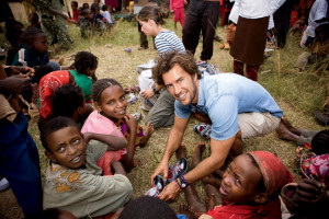 Blake Mycoskie outfitting Argentine children with fancy new footwear.