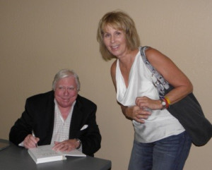 Dr Jerome Corsi is pictured autographing a copy of his latest book