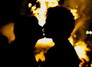 couple kisses in front of a bonfire in this 2005 file photo. An ...