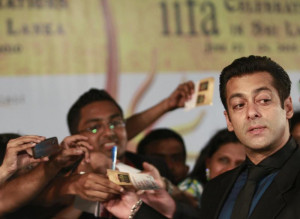 Bollywood actor Salman Khan (R) reacts on the green carpet for the ...