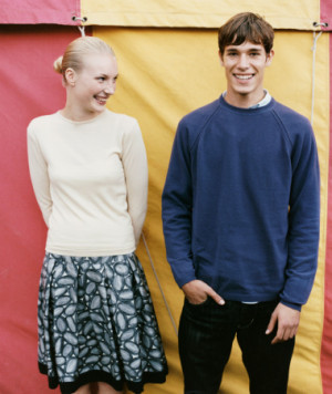 Teenage Boy and Girl Stand Side by Side in Front of a Fairground Tent ...