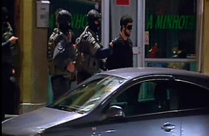 reuters vtm masked police escort a man from a house
