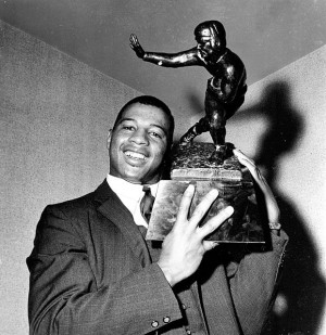 Ernie Davis, halfback for Syracuse, holds the Heisman Memorial Trophy ...