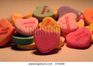 or Photo of Assorted heart candy with sayings, with a blank pink heart ...