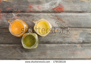 juice served in three glass jugs on an old weathered wooden picnic ...