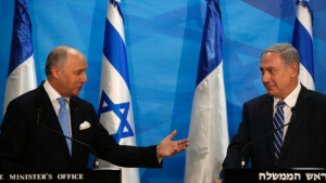 French Foreign Minister Laurent Fabius gestures towards Israeli Prime ...