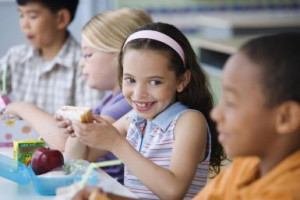 Students eating healthy lunch in cafeteria - Blend Images - Jose Luis ...