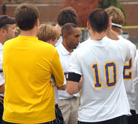 Shawn Jackson, middle, is huddled by his players before a game in 2010 ...