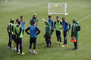 Amos Magee explains a short field passing drill to the group of ...