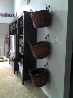 Hang baskets on wall of family room for blankets, remotes, and general ...