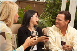 Picture of Three Friends Enjoying Wine on an Outdoor Patio.