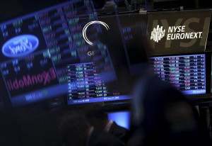 ... in monitors showing stock quotes at the New York Stock Exchange