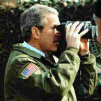 Bush looking through binoculars still covered