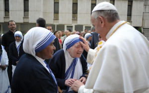 Pope Francis blesses a member of the Missionaries of Charity during a ...