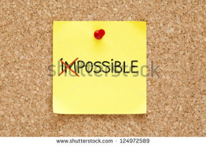 The word Impossible turning into Possible on yellow sticky note ...