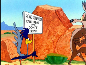 Road Runner stops at the stand, whizzes by and returns with a sign:
