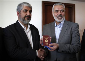 Senior Hamas leader Ismail Haniyeh (R) gives Hamas chief Khaled ...