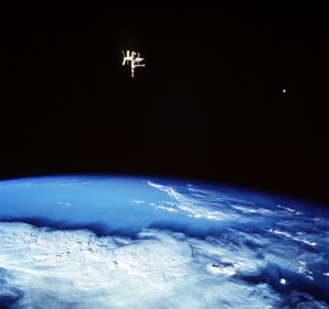 ... Space Shuttle Discovery photographed this view of two satellites of