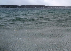 ice balls rolling up on the shore of lake michigan
