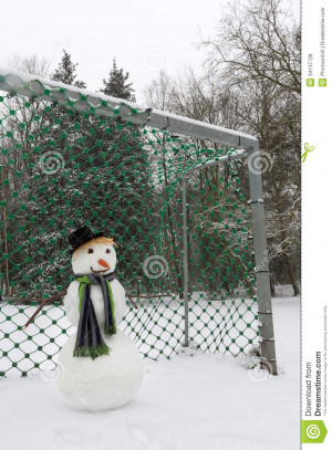 Funny snowman defending the soccer goal in the park.