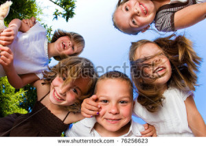 Kids Huddle Having Fun And Looking Down Stock Photo