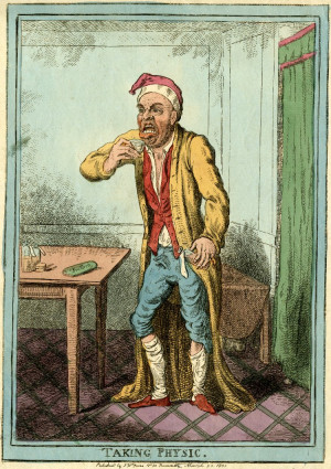 man in a dressing gwon and cap pulls a face, as he lifts a glass of ...