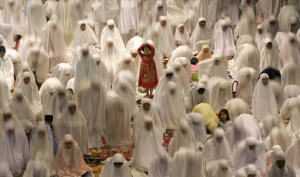 Muslim women attend prayers on the eve of the first day of the Islamic ...