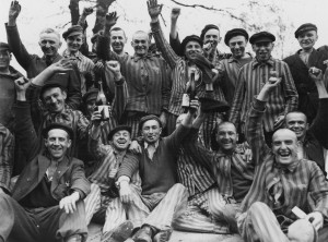 Dachau survivors toast their liberation. The man standing in center ...