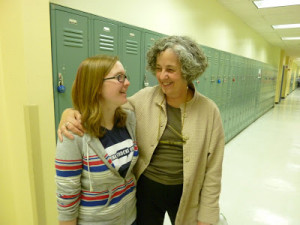 recent alumna greets Parent Coordinator Judy Moore.