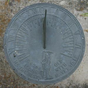 This sundial displays a likeness of Father Time. Its motto quotes ...