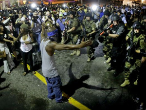 Police arrest a man as they disperse a protest on Aug. 20, for Michael ...