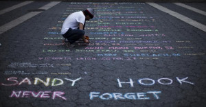 Street artist Mark Panzarino, 41, prepares a memorial as he writes the ...